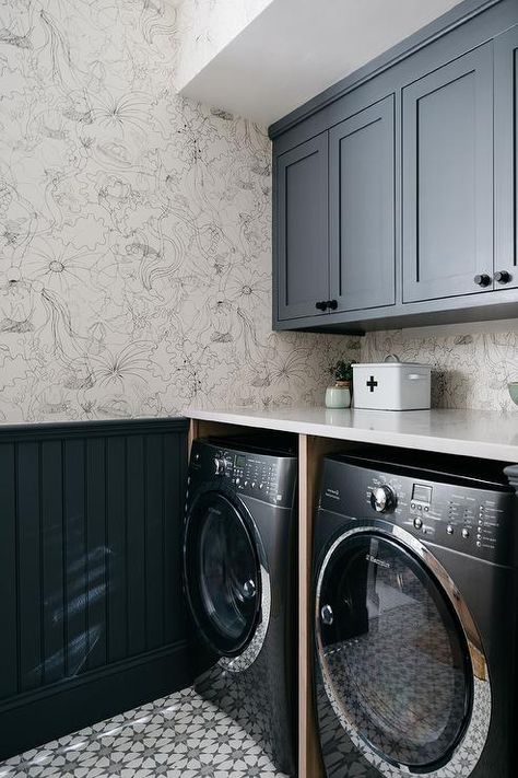 Cottage mudroom and laundry room designed with dark blue shaker cabinets and oil rubbed bronze knobs over an enclosed black front washer and dryer set. Black Washer Dryer, New England Style Homes, Kate Marker Interiors, Stylish Laundry Room, Laundry Room Wallpaper, Laundry Cabinets, Modern Laundry Rooms, Laundry Room Ideas, Laundry Room Cabinets