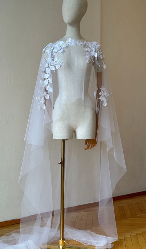 Short lace cape,bridal cape, floral wedding cape, bride cape, floor length veil, capelet, wedding cape, custom cape/bespoke cape Handcrafted with dedicated lace and illusion tulle. Materials: lace, illusion tulle. Colour: white  The cape can be made at your preferable measurements. Veil care: hang and steam. If you want to order a long veil write me please. I will gladly prepare a personal wedding cape or other decoration for you. You can send me a photo of a example you would like to recreate o Wedding Cape Sleeves, Pearl Cape Wedding Dress, Lace Wedding Cape, Bride Cape, Winter Wedding Cape, Wedding Cape Veil, Floor Length Veil, Slytherin Fashion, Lace Capelet