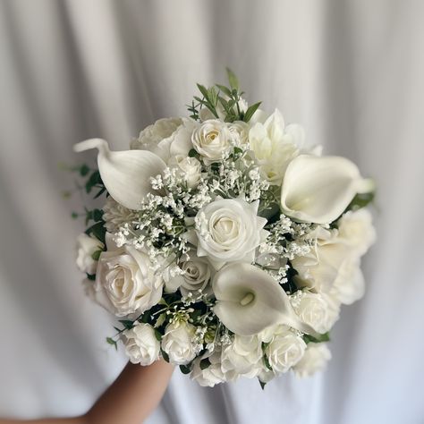 These beautiful artificial wedding bouquets are made from faux flowers of white and off white, sage greenery and silk eucalyptus. They will make the perfect addition to your big day!  This bridal bouquet consists of white roses, peonies and dahlias with green silk eucalyptus and sage greenery and fillers. The stems are wrapped in twine. The bridal bouquet pictured is 12" (30 cm). Bouquet Size Available: Bridal Bouquet- 12" (30 cm) Bridesmaids Bouquet - 7" (17 cm) Toss bouquet 6" (15 cm) Matching bridesmaids bouquets, toss bouquet, corsages and boutonnières and other accessories are available. White Bouquet Wedding Peonies, Bouquet Wedding Dusty Rose, Bridal Flowers Bouquet White And Green, Bridal Bouquet White And Champagne, White Wedding Bridal Bouquet, Wedding Flower Bouquets For Bride, Sage Green And White Flowers, Ivory Flower Bouquet, Bridesmaid Bouquet Peonies