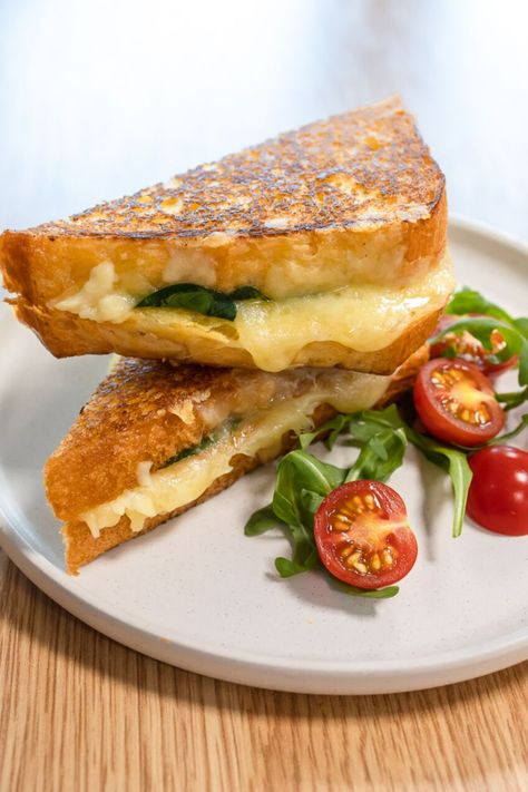 A grilled cheese on a plate with rocket and sliced cherry tomatoes on a wooden table. Brioche Bread Sandwich Ideas, Brioche Sandwich Ideas, Brioche Bread Sandwich, Brioche Grilled Cheese, Brioche Sandwich, Air Fryer Grilled Cheese, Grilled Cheese Sandwich Recipe, Brioche Loaf, Cheese Sandwich Recipe