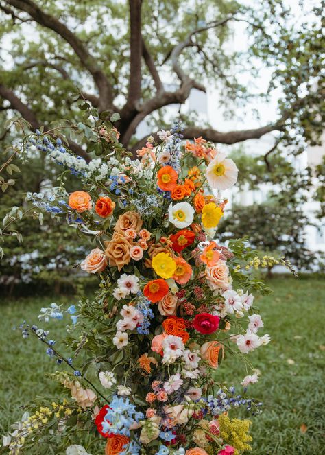 bright orange, coral, blue wedding flowers Primary Colors Wedding, Vibrant Wedding Florals, Orange Pink And Blue Wedding, Orange Blue Wedding Theme, Bright Fall Wedding Flowers, Blue Orange Pink Wedding, Light Blue And Orange Wedding, Orange And Pink Wedding Theme, Ground Floral Arch