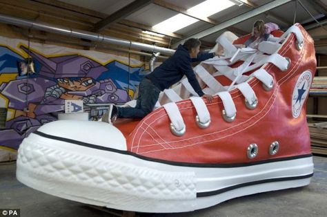 Old women the world over will be queueing up to live in this gigantic replica of a Converse Chuck Taylor All Star. At 9 feet high and 18 feet long it's a it's a UK size 845. Ready Set Move Vbs, Lighting Sculpture, Converse Tennis Shoes, Guinness Book Of World Records, Diy Sneakers, Vbs 2023, Red Converse, Guinness Book, Sneaker Art