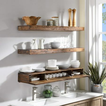 Stylize your kitchen with these decorative but functional floating wall shelf. Deep enough to showcase ceramic ware, the thick distressed wood design makes this piece both visually substantial and structurally rigid. A concealed internal compartment can store teas, tools, and more. Installation is very easy, and includes a french cleat. Made from quality Acacia hardwood, this unit will make a great highlight piece for your kitchen. Color: Brown. Lights Over Floating Shelves Kitchen, Reclaimed Wood Kitchen Shelves, Rustic Floating Shelves Kitchen, Open Shelving In The Kitchen Wall Shelves, Floating Shelves In The Kitchen, Wooden Floating Shelves Kitchen, Kitchen Wooden Shelves, Floating Shelves Kitchen Decor, Floating Live Edge Shelves