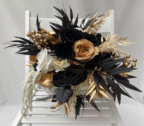 Limited Edition Custom Artificial Black Gold & Ivory Gothic Boho Style Bouquet. This bouquet has been hand made with quality Silk, Velvet flowers & rustic foliage. The bouquet handle has been hand tied in wrapped colour coordinated silk ribbon.  This bouquet is approximately 12 inches (30cm) in Diameter. There are only three of these bouquets available. Prom Bouquet With Black Dress, Black And Gold Floral Arrangements, Black And Gold Wedding Flowers, Black Prom Bouquet, Black And Gold Wedding Bouquet, Black And Brown Wedding Color Schemes, Gold And Black Flowers, Black And Gold Flower Arrangements, Black And Gold Floral Centerpieces