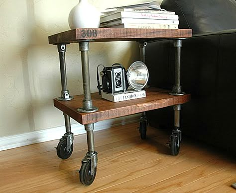 Thick wooden shelves, aged iron piping and stenciled numbers give this next item true character. Once again, casters allow for motion, which can be handy for a side table in a small space. Industrial Furniture Table, Industrial Vintage Decor, Industrial Pipe Furniture, Modern Industrial Furniture, Industrial Side Table, Vintage Industrial Decor, Industrial Design Furniture, Vintage Industrial Furniture, Pipe Furniture