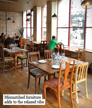 Mismatched furniture - could be painted with cx colours and used in the canteen? Mismatched Chairs Restaurant, Mismatched Furniture Cafe, Community Cafe Ideas, Cottagecore Cafe, Eclectic Cafe, Community Cafe, Takeaway Shop, Thrifted Furniture, Restaurant Kitchen Design