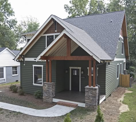 Earth tones add warmth and texture. We love the look of this home in Rifle with mountain sage colored siding, white trim, and stone accents. Green Exterior House Colors, Green House Exterior, Green Siding, Lake Houses Exterior, House Paint Color Combination, Exterior House Paint Color Combinations, Exterior House Color, James Hardie, Cabin Exterior