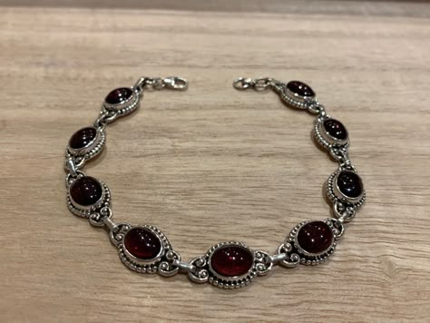 Lovely garnet and sterling silver bracelet. The bracelet has 9 individual garnet in an oval shape.  The bracelet measure 21 cm long and it is almost 0.8 cm wide. The bracelet can be  easily  adjusted from 21 cm to 17 cm.  The high quality of our stones is what it makes this bracelet so precious.  A perfect present for her on any occasion St Valentine Day, Birthday, Anniversary, Travelling or Christmas. Your bracelet will be pack in our lovely Kallpa bag. If the destination is outside UK the pack St Valentine, Edgy Jewelry, Red Bracelet, Garnet Bracelet, Red Bracelets, Dope Jewelry, Garnet Jewelry, Bracelet Chain, Funky Jewelry