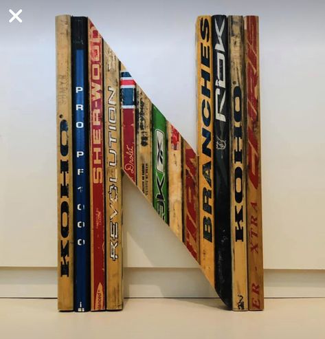 Sports Room Decoration, Hockey Diy Projects, Hockey Stick Crafts Diy, Hockey Stick Display Ideas, Hockey Stick Shelves, Diy Hockey Decor, Repurposed Hockey Sticks, Old Hockey Stick Ideas, Hockey Stick Wall Decor