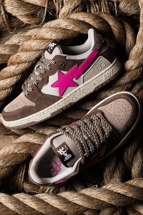 As its name implies, BAPE’s SK8 STA is heavily inspired by skateboarding culture and its design owes to some of the most popular skate silhouettes on the market. In addition to the leather overlays, the sides are adorned with A BATHING APE’s signature STA logo. These sneakers arrives in unique mix of brown and tan shades, offset by the bright pink STA logo.⁠ Bape Shoes Brown, Bape Sneakers Outfit, Bape Sk8 Sta, Tan Shades, Sk8 Sta, Bape Shoes, Bape Sneakers, Pretty Sneakers, Shoes Names