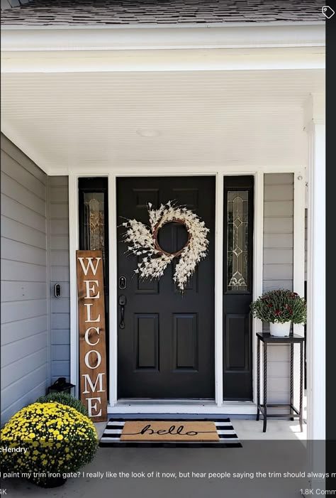 Front Door Decor Black Door, Black Door Tan House, Black Door Front Porch Decor, Black Front Door And Black Shutters, Black Front Door Ranch House, Tan House Door Color Ideas, Black Front Door Tan House, Small Porch Ideas Entrance, Outdoor Apartment Decor Front Doors