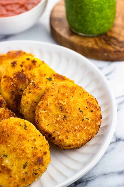 Coated with Italian-seasoned breadcrumbs and Parmesan, these pan-fried polenta slices make a quick appetizer or small plate. They're delicious served with marinara sauce and basil pesto as dipping sauces. What To Serve Over Polenta, Quick Polenta Recipes, Fried Polenta Recipes Easy, Polenta Recipes Tube Baked, Polenta Tube Recipes Easy, Polenta With Shrimp, Polenta Roll Recipes, How To Cook Polenta Tube, Instant Polenta Recipes