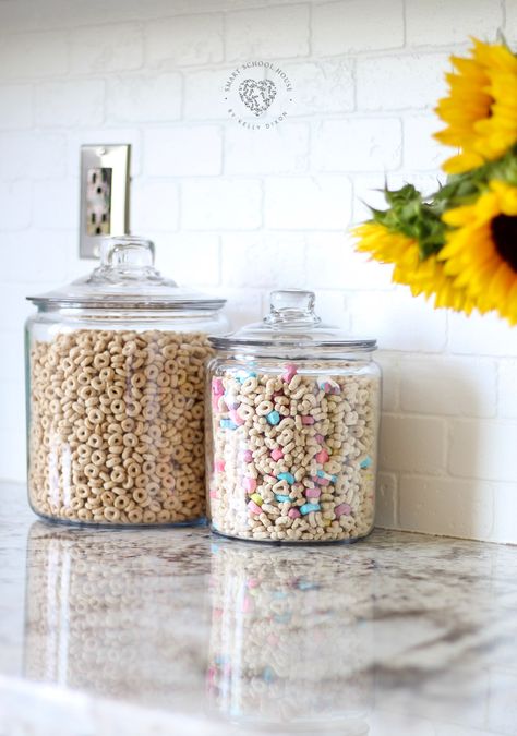 Cheerios and Lucky Charms in glass jars on my kitchen counter. Adds a warm, charming, and kid friendly energy to our family kitchen Kitchen Counter Organization, Kitchen Counter Decor, Counter Decor, Kitchen Jars, Family Kitchen, Stunning Kitchens, Farmhouse Style Kitchen, Modern Farmhouse Kitchens, Lucky Charms