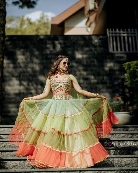 We are loving this bride’s haldi lehenga. The ruffled panelled skirt with sorbet colours looks super fresh and chic. The multicolour blouse looks just so pretty with that small latkan at the edges. Pc: studiokellyphotography #indianwedding #wedding #indianbride #bride #indiangroom #groom #hairstyles #bridal #wittyvows #lehenga #mehendioutfit Haldi Unique Outfit For Bride, Mehndi Dress Ideas For Bride, Mehndi Outfit Ideas For Bride, Best Haldi Outfits For Brides, Mehndi Outfit Bridal Indian, Unique Mehendi Outfits For Bride, Haldi Dress Ideas For Bride, Haldi Dress For Bride Indian, Unique Haldi Outfits For Bride