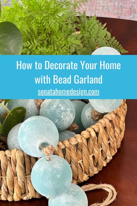 Looking to elevate your home decor and add a touch of elegance? Bead garland might just be the answer! With an array of colors, styles, and textures, there are many ways this charming home decor idea can instantly transform any space. From stylish home accents to creative decor tips, we have all the tips and ideas on how to decorate with budget friendly bead garlands Go to the Sonata Home Design blog for more details and inspiration! Home styling, unique decor ideas, kitchen decor, living room. Beach Bowl Decor, Styling Beads Decor, Decorating With Beads Garland, Coastal Tray Decor Ideas, Decorating With Beads, Large Bowl Decor Ideas, Bead Garland Decor Ideas, Bowl Decor Ideas, Bead Garland Decor