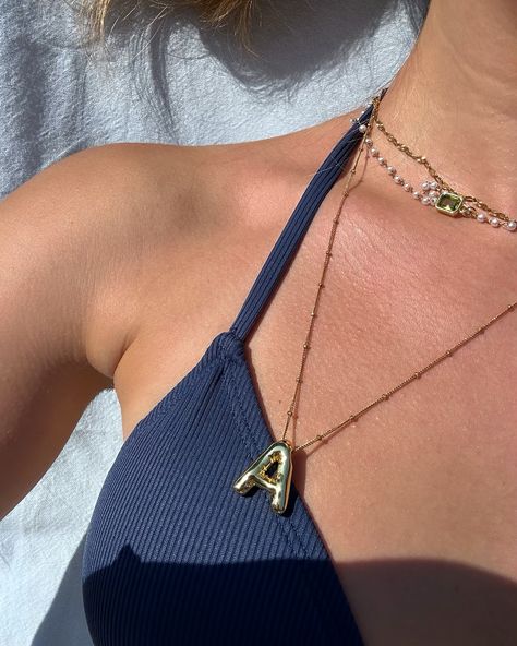 Spotted 👀 Our custom Bubble Initial pendant necklace paired with our sunburst chain & the newest drop — our pearl necklace. Pur custom chains are available in-store and at pop-ups only. DM us to book! 🖤 @sarah.lemire #coastaljewelry #customnecklace #customjewelry #montreal #quebec #pearlnecklace #goldgirlie #jewelrystack #jewelryinspo #waterproofjewelry Bubble Necklace Outfit, Necklace With Initials, Elegant Summer Outfits, Coastal Jewelry, Bubble Necklace, Bubble Necklaces, Wrist Jewelry, Pop Ups, Montreal Quebec