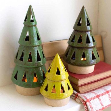 Create effortless style in your holiday living room with the Ceramic Christmas Tree Lanterns - Set of 3, made with rustic green and yellow finishes. Ceramic Set of three Small: 4 1/2"Dia. x 6"H; Medium: 5"Dia. x 8 1/2"H; Large: 4 3/4"Dia. x 11"H Wipe clean with dry cloth Glazed multi finish Wooden Pillar Candle Holders, Tree Lanterns, Holiday Living Room, Large Lanterns, Christmas Tree Candles, Lantern Set, Beautiful Trees, Ceramic Christmas Trees, Candle Tree