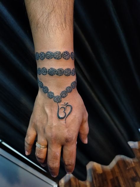 #Rudraksha tattoo designs #om tattoo designs #best tattoo studio #raipur chhattisgarh #9589557355 Rudraksha Tattoo On Wrist, Om Tattoo Hand, Rudraksh Tattoo Design, Rudraksha Tattoo Design, Om Tattoo Men, Rudraksha Tattoo, Om Tattoo Designs, Poor Quotes, Prince Tattoo