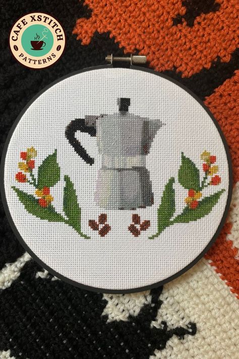 This pin shows my espresso maker & coffee plant cross stitch pattern on top on a crocheted blanket. Coffee Embroidery Patterns, Food Cross Stitch Patterns, Plant Cross Stitch Pattern, Cross Stitch Coffee, Food Cross Stitch, Coffee Cross Stitch, Plant Cross Stitch, Coffee Embroidery, Stitch Coffee