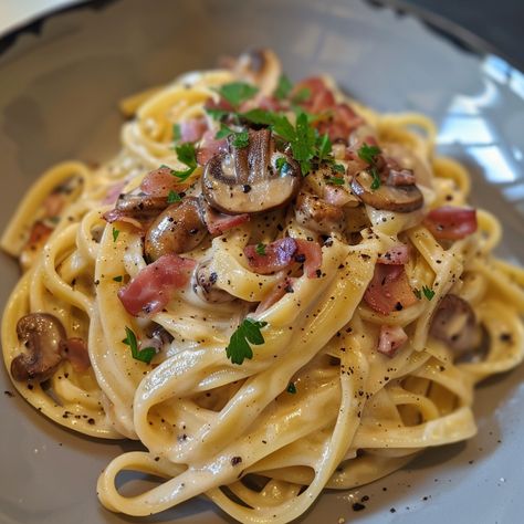 Recipe for Tagliatelle Carbonara with Mushrooms Ingredients: 400g tagliatelle 200g pancetta or bacon, diced 200g mushrooms, sliced 3 large eggs 100g grated Parmesan cheese 2 cloves garlic, minced 1/2 cup heavy cream (optional for creamier texture) Salt and freshly ground black pepper to taste 2 tablespoons olive oil Fresh parsley, chopped (for garnish) Instructions: Cook the Pasta: Bring a large pot of salted water to a boil. Add the tagliatelle and cook according to the package instructions... Mushroom Bacon Pasta, Pasta With Sauce, Tagliatelle Carbonara, Pasta Tagliatelle, Pasta With Mushrooms, Mushroom Pasta, Western Food, Yummy Comfort Food, Quick Dinner Recipes