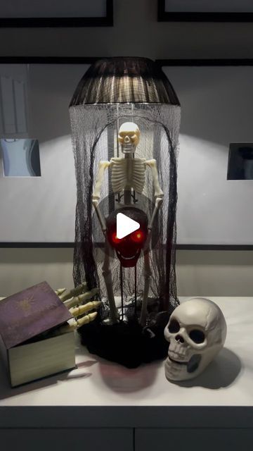 Kendra Davis on Instagram: "💜💀DIY Skeleton Lamp💀💜

Hey-hey L🖤VES! 

It is time to start the Fall/Halloween DIY’s/crafts💜.

Here a super cute skeleton lamp I made using only Dollar Tree items!

💜I started by zip-tying 2 paper towel holders together. 
💚I spray painted it black. 
💀I hot glued a skeleton on the front of the paper towel holders 
🖤I then got glued a black light up skeleton head in the hands of the full body skeleton 
💜 I put a multi colored, battery operated puck light, facing down on top of the paper towel holder 
💚I spray painted a plastic bowl black 
💀 Then draped a black Creepy-cloth over the entire piece 

I think it turned out super cute! 

🖤Let me know what you think 🖤

#diy #diycrafts #halloween #halloweencrafts #halloweendiy #dollartreediy #dollartreecraf Paper Towel Holder Crafts, Dollar Tree Paper Towel Holder Crafts, Diy Halloween Dollar Tree, Dollar Tree Diy Halloween Decor, Skeleton Toilet Paper Holder, Black Creepy Cloth Halloween Decor, Skeleton Candle Diy, Fairy Skeleton In A Jar Diy, Full Body Skeleton