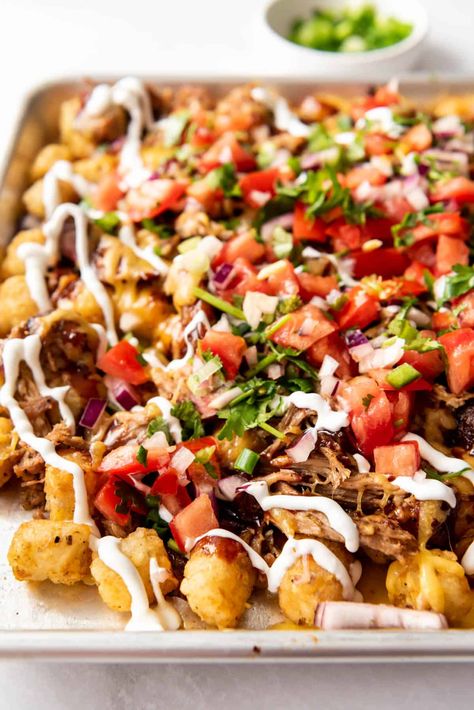 Crispy seasoned tater tots are the star of the show in these savory BBQ Pulled Pork Totchos! They are loaded with plenty of melted cheddar cheese, shredded pulled pork, BBQ sauce, pico de gallo, sour cream, and more for a show stopping Game Day appetizer or a fun casual dinner for the fam! #totchos #tatertots #tatertotnachos Seasoned Tater Tots, Pork Totchos, Totchos Tater Tots, Pork Bbq Sauce, Pulled Pork Bbq Sauce, Appetizers Football, Loaded Tater Tot, Totchos Recipe, Tot Nachos