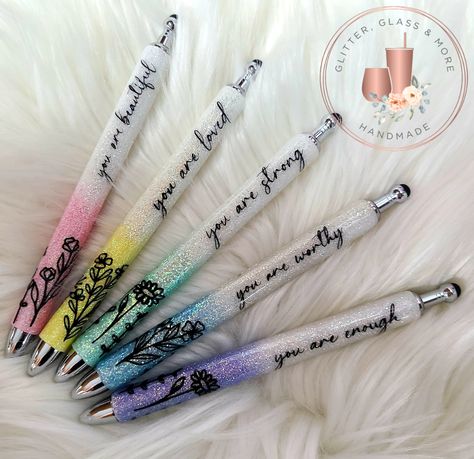 This listing is for our new custom pastel glitter pens with inspirational quotes. These pens are sold either individually or as a complete set of 5 pens. Our pens are all refillable and each comes with an additional refill. Each pen/set is made to order using a stainless steel base, painted and glittered using quality glitter before being decaled and sealed. Each pen also comes complete with a built in stylus for us with your smart phone or tablet. These pens are available in the following quote Glitter Pen Sayings, Inspirational Glitter Pens, Glitter Ink Pens, Nurse Pens Epoxy, Custom Glitter Pens, Fall Glitter Pens, Glitter Resin Pens, Epoxy Glitter Pens, Resin Pen Ideas