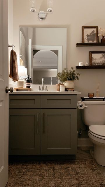 Bathrooms Sinks And Vanities, Bathroom Decor Styling, Powder Room Over Toilet Ideas, Apartment Bathroom Dark Cabinets, Moody Bathroom Cabinets, Boho Modern Bathroom Decor, Small Home Office Window, Small Bathroom With Round Mirror, Windowless Guest Bathroom