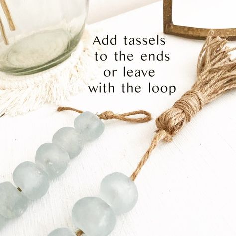 Brandi Stimpson Owner/Designer on Instagram: “Which is your favorite? We definitely sell 50% more of one over the other.... But tell me your fave.... tassels or a loop at the end? 👇🏻” Coastal Garland, Sea Glass Decor, Glass Garland, Home Decor Coastal, Beach House Gift, Coastal Farmhouse Decor, Sea Glass Beads, Scandi Decor, Farmhouse Boho