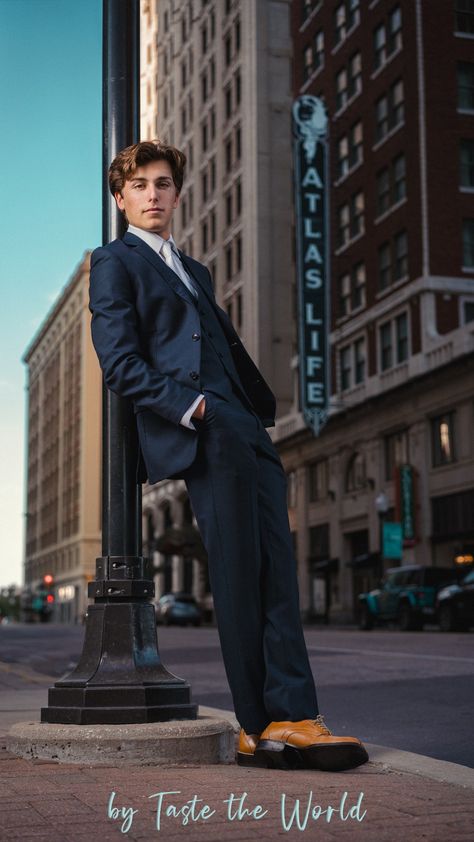 A senior boy in downtown Tulsa. He's wearing a cool blue suit and leaning on a light post with his hands in his pockets. He looks relaxed and cool. Male Clothing Model Poses, Prom Photos Guys, Men Poses Photography Ideas Photo Shoot, Dressy Senior Pictures, Senior Picture Ideas For Guys Downtown, Guy Leaning On Wall, Senior Portraits Boys Posing Ideas, Suit Senior Pictures, Senior Pictures Suit