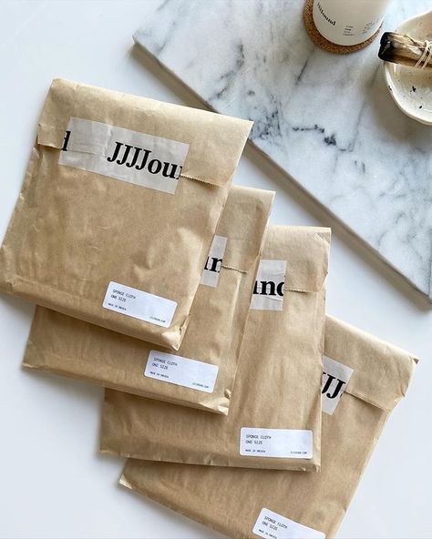 JJJJound (@jjjjound) • Instagram photos and videos Paper Sleeve Packaging, Packaging Ideas For Clothing, Clothing Brand Packaging, Clothing Booth, Clothing Booth Display, Shopping Bag Design, Bazaar Ideas, Packaging Ideas Business, Ecommerce Shop