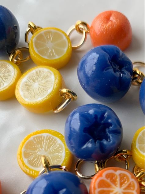 Handmade polymer clay charms to be worn on hoop earrings.  Tiny blueberry’s, lemon slices, and orange slices scattered on white background. Polymer Clay Food Charms, Kawaii Business, Polymer Charms, Kawaii Ideas, Clay Modelling, Blueberry Picking, Clay Inspo, Clay Keychain, Clay Magnets