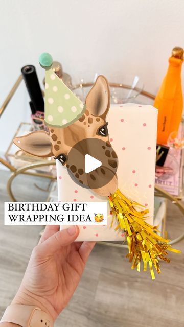 Shelby | Gift-in-a-Box Guide on Instagram: "YOU’RE NOT READY FOR HOW CUTE! 🥳🎁🦒  Comment ZHUZH for the animal garland & everything else I used to wrap this gift!   This is a new way to use the cute party horns for gift wrapping! Just grab a cute animal garland / cutout and add the blower using hot glue or foam tape to secure it   The garland came with 20 die cut animals and the party horns come in a pack of 6 so you can easily rinse and repeat this same method for a bunch of gifts!   I also ended up adding some letter beads to the top right corner for the name which made it even cuter  An easy way to create a Pinterest-esque gift! ✨  What should we name him?!?  #birthday #birthdaygifts #bdaygift #birthdaygiftideas #giftwrappingideas #giftwrapping #giftwrappinginspiration #giftwrappingins Animal Wrapping Ideas, Unicorn Gift Wrapping Ideas, Stuffed Animal Gift Wrapping Ideas, Fun Ways To Wrap Birthday Gifts, First Birthday Wrapping Ideas, Fun Gift Wrapping Ideas Birthdays, Fun Birthday Wrapping Ideas, 1st Birthday Gift Wrapping Ideas, Animal Gift Wrapping Ideas