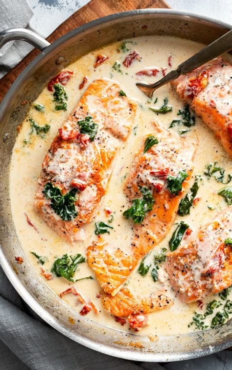 Tender salmon filets smothered in a rich garlic cream sauce filled with sun-dried tomatoes, kale and Parmesan cheese. Restaurant quality salmon, in 30 minutes! #salmon #seafood #fish #creamsauce #30minutemeal #easyrecipe #tuscan #Italian #sundriedtomatoes #kale #spinach Creamy Garlic Tuscan Salmon, Italian Salmon, Tuscan Salmon Recipe, Cheese Restaurant, Tuscan Salmon, One Pan Recipe, The Chunky Chef, Salmon Filets, Chunky Chef