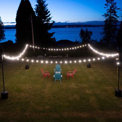 Create instant ambiance by hanging string lights indoors or outdoors using durable IYN String Light Pole Stands. Easily hang string lights for backyards, patios, weddings, restaurants, events, and more. A tank stand can be set up and torn down with no hardware attached to the surface it stands on. The tank stand is filled with water or sand and can be placed anywhere, outside or inside. The durable powder-coated poles are 9’6” tall when assembled and allow you to hang G40 string lights in spans String Lights Indoors, Yard String Lights, Grass Patio, Hanging String Lights, Pole Stand, Tank Stand, Icicle Lights, Indoor String Lights, Light Pole