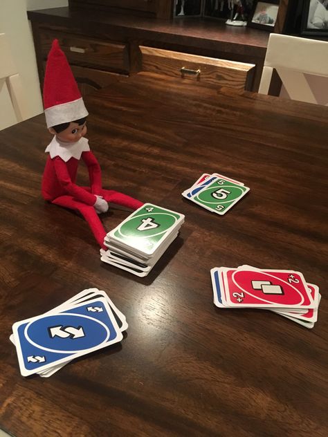 Elf with uno deck Elf Playing Uno, Elf On The Shelf, Christmas Fun, Elf, Playing Cards, Shelves, Holiday Decor, Christmas, Quick Saves