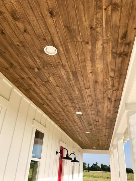 Love this color of wood with the wood grain. Would prefer lights to be hanging down instead of recessed. Can Lights In Wood Ceiling, Black Tin Porch Ceiling, Wood Ceiling On Front Porch, Wood Under Porch Ceiling, Porch Remodel, Porch Ceiling, Front Porch Design, Exterior Remodel, Ceiling Ideas