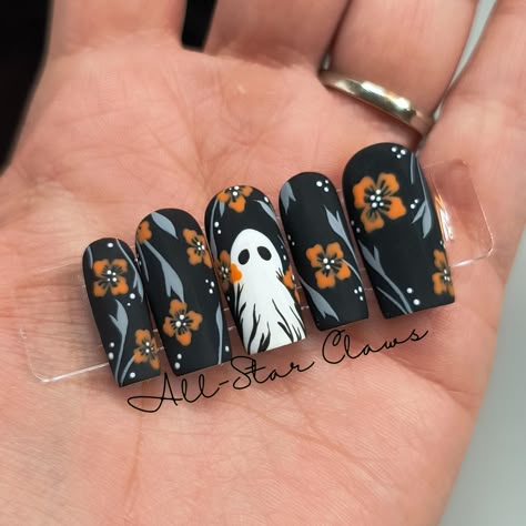 All nails have a black gel base color with grey vine\leaves orange flowers and white dots. The middle nail has a white ghost plus the flower and vine design. All nails have a matte top coat finish. All nails have a builder gel layer. Available in different shapes and lengths. **Please measure your nails for the XXL length and select "XXL Custom Sizes" then send me your measurements.** Each order comes with a nail prep kit which includes nail glue, nail adhesive tabs, nail file, buffer, cuticle stick, alcohol wipes, and instructions. Please don't hesitate to ask me any questions. Ghost Fall Nails, Matte Black Wedding Nails, Halloween Stamped Nails, Professional Halloween Nails, Ghost Flower Nails, Matte Halloween Nail Designs, Halloween Spooky Nails, Marigold Nails, Halloween Nails Matte