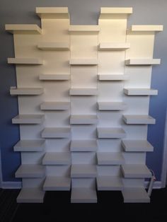 Wall of book shelves!  Ikea Lack book shelves mounted together in a staggered pattern to create built in bookends for the other shelves!