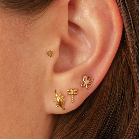 🐙✨ Dive into style with our Tiny Octopus Threadless Earrings! Perfect for mixing and matching, these unisex pieces are sold individually, so you can create your own unique look. Available in multiple finishes! 🦋 Add a touch of whimsy with our Dainty Dragonfly Threadless Flat Back Studs! Great for tragus, lobe, or helix piercings, these delicate designs are perfect for stacking or wearing solo. 🦖 Channel your inner dino-lover with our Dainty Stegosaurus Threadless Earrings! These fun studs a... Threadless Earrings, Tiny Octopus, Helix Piercings, Helix Piercing, Tragus, Helix, Octopus, Piercings, Create Your Own