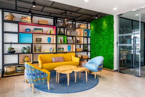 Browse All Offices | Office Snapshots Coworking Reception Design, African Inspired Office Design, Contemporary Office Design Workspaces, Office Space Divider Ideas, Vibrant Office Space, Creative Office Space Workspaces Design, Vibrant Office Design, Office Lounge Area Design, Office Reception Seating