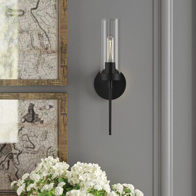 This wall sconce adds a curated look to your bedroom or entryway with its bold lines and tube-shaped bulb. Made from stainless steel, this hard-wired light features a round backplate with a drum-shaped glass shade and can be mounted with the light facing up or down. It uses one T10 100W bulb and is dimmable, letting you get the light just right. Plus, it's rated for use in damp areas, so it's great for framing your bathroom mirror or shower. Finish: Matte Black | Greyleigh™ Willingham 1 - Light Bathroom Lighting Side Of Mirror, Sconces Next To Tv Living Room, Sconses Hallway Modern, Battery Operated Sconces Wall Mount, Gold Sconces Bathroom, Wall Sconces Entryway, Battery Sconces Wall Mount, Mirror With Sconces On Each Side, Fireplace Sconces Lighting