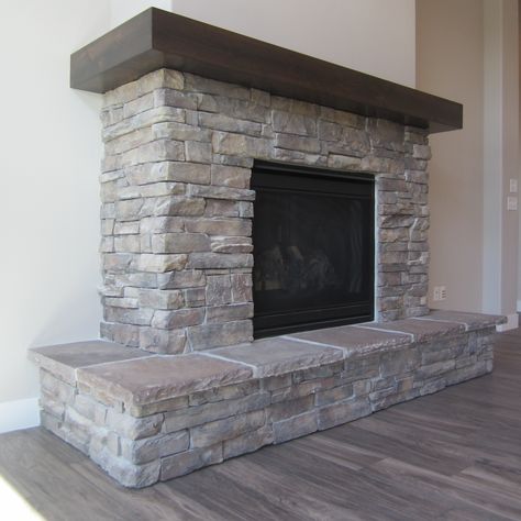 Fireplace Mantels Wrap Around, Short Stone Fireplace, Fireplace With Wrap Around Hearth, Wrap Around Hearth Fireplace, Fireplace Raised Hearth Ideas, Wrap Around Wood Mantle, Wrap Around Mantel Fireplace, Fireplace Wrap Around Mantle, Gray Rock Fireplace