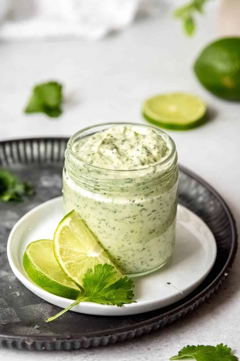 This Creamy Garlic Lime Cilantro Sauce recipe melds jalapeño, cilantro, garlic, & lime into a creamy condiment that's a must-have in your kitchen. Whipped up in just 5 minutes with only 5 ingredients, it's ideal for dressing up everything from grilled meats to your morning eggs. Think of it as the versatile 'little black dress' for your fridge—essential for any season and superbly adaptable. Whether used as a spicy spread, a zesty dip, or a bold dressing, it's sure to become your go-to sauce! Peruvian Green Sauce Recipe, Creamy Jalapeno Sauce, Pollo Tropical, Green Sauce Recipe, Cilantro Garlic Sauce, Creamy Jalapeno, Garlic Sauce Recipe, Jalapeno Sauce, Cilantro Lime Sauce