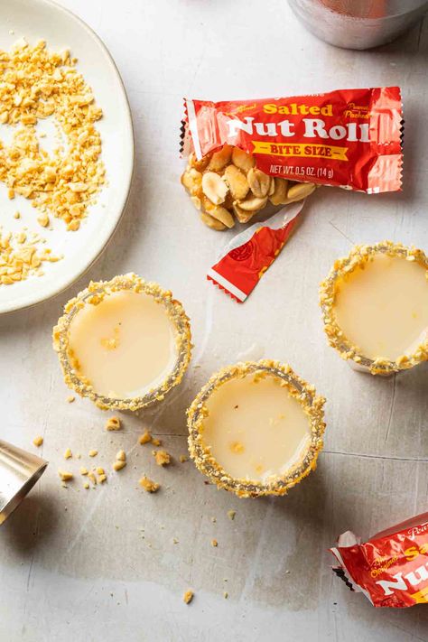 Inspired by the classic candy bar, the salted nut roll shot is made with peanut butter whiskey, hazelnut liqueur with a touch of cream and a pinch of salt. This fun, creamy shot is perfectly salted and served in glass rimmed with chopped peanuts. Salted Nut Roll Shot, Salted Nut Roll, Salted Nut Rolls, Peanut Butter Substitute, Mcdonalds Recipes, Peanut Butter Whiskey, Nut Roll, Blackberry Margarita, Strawberry Cream Pies