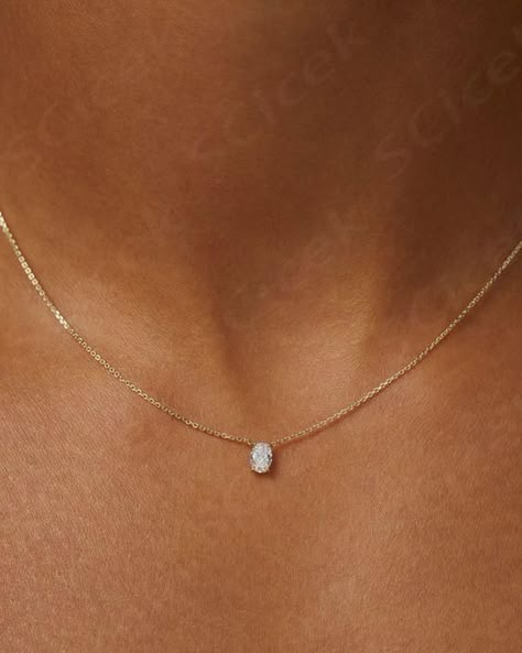 Our Solitaire Oval Diamond Necklace is strung with a dainty round cut diamond. Cast from solid 18-karat gold, it's suspended from our signature fine chain. A piece so delicate it gives the appearance of ‘floating’ on the neckline, let this piece speak quiet volumes on its own, or layer it with other fine necklaces from your collection.  ... more Pearl And Diamond Necklace Simple, Everyday Diamond Necklace, Simple Diamond Necklace, Money Necklace, Diamond Necklace Simple, Wedding Jewelery, Floating Diamond Necklace, Minimal Jewellery, True Summer