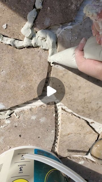 Sarahli Wilcox on Instagram: "Crazy Paving Tutorial ~  I can't believe how different this space looks! We went from a cracked, stained concrete slab under our gazebo to this natural stone masterpiece.  To get started on your patio deck dreams, when in doubt & on a budget, source  on offerup or FB marketplace, I found these 18” x 18” travertine stone tiles for $150 for over 300 pieces . In the end, I only used about 40-60 pieces, and I ended up selling the rest. If you want it to be, it can be really cost effective! In total I spent under $400 for this 144 sqft. space, probably less knowing now that I would sell the rest of the tiles.  To get the look, you’re going to have to break them into a variety of sizes depending how you want the final look. I’ve seen so many color & types of stones Concrete Stone Walkway, Concrete And Stone Patio, Crazy Paving Travertine, Diy Paving Ideas, Outdoor Tiles Over Concrete, Patio Tiles Over Concrete, Outdoor Tile Over Concrete, Diy Stone Patio, Dog Porch