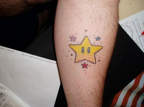 When it comes to geometric shapes, stars are pretty much the superstars of the group. As such, tattoos of stars are pretty common. But some of the starry ink out there is definitely worth another look. From design style, color choices, and content, star pieces often reflect individual interests, Mario Star Tattoo, Super Mario Tattoo, Star Tattoo Meaning, Mario Tattoo, Mario Star, Wrist Tattoo Cover Up, See Tattoo, Meaningful Tattoo Quotes, Small Tattoos With Meaning