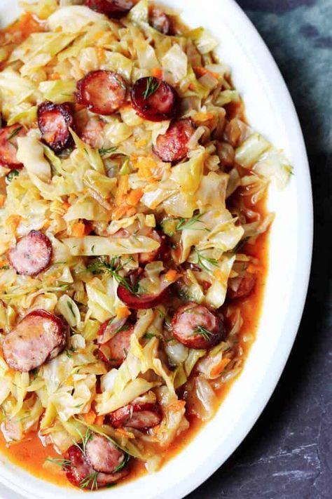 Kielbasa and Cabbage come together to form a perfect Polish summer hunter's stew. It's made from young cabbage, that is at its peak at the begging of the summer, with the addition of a smoky Polish sausage and a fragrant dill. It makes for a delicious European treat. #cabbage #kielbasa Cabbage And Kielbasa, Polish Sausage Recipes, Hunters Stew, Kielbasa And Cabbage, Kielbasa Recipes, Cabbage And Sausage, Polish Sausage, Cooked Cabbage, Asparagus Soup