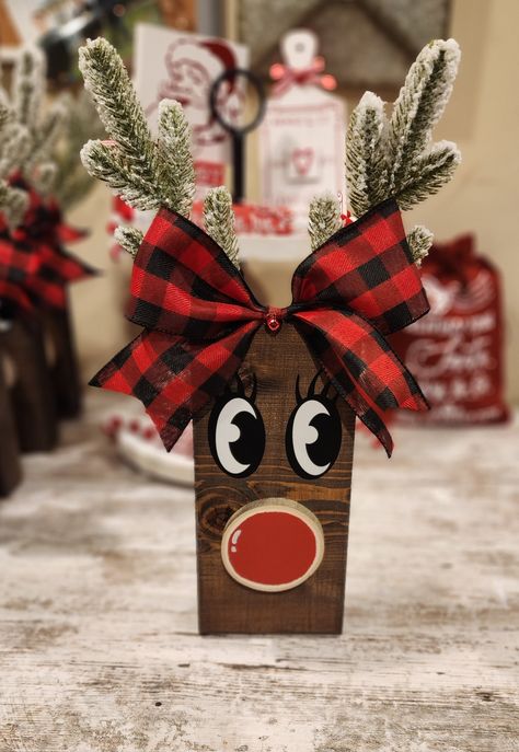 This adorable reindeer is made from a quality solid wood and stained in a beautiful mocha brown. Also adorning a cutie little buffalo check bow with a sweet little red bell. This reindeer will be the perfect addition to any holiday decor this year, or it would also make a great gift for that special Christmas lover in your life. Stands 15 inches high with the beautifully flocked pine antlers. Diy Holiday Wood Projects, Wood Crafts Decor, 4x4 Holiday Wood Crafts, Projects Out Of Pallets, Reindeer Wood Blocks, Wood Christmas Packages, Wood Plank Reindeer, Wood Deer Christmas, Christmas Crafts With 2x4 Wood